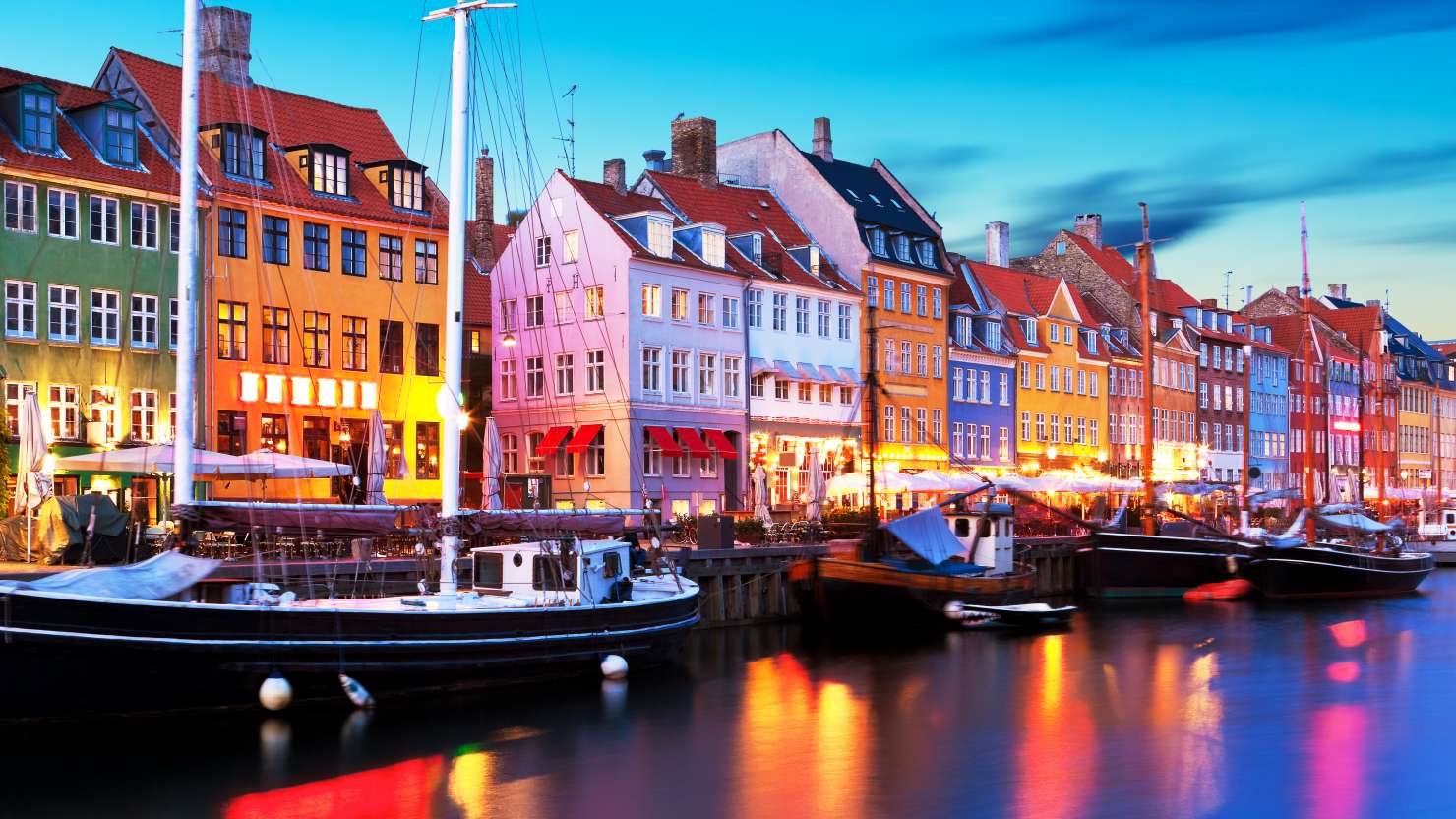Boats moored alongside Nyhavn Quayside in Copenhagen, Denmark