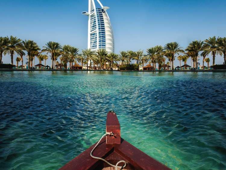 Boat in sea next to beach in Dubai