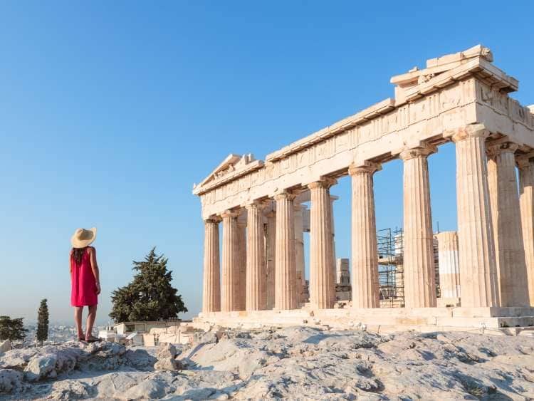 Woman looking at the famous Parthenon temple on the Acropolis, Athens, Greece