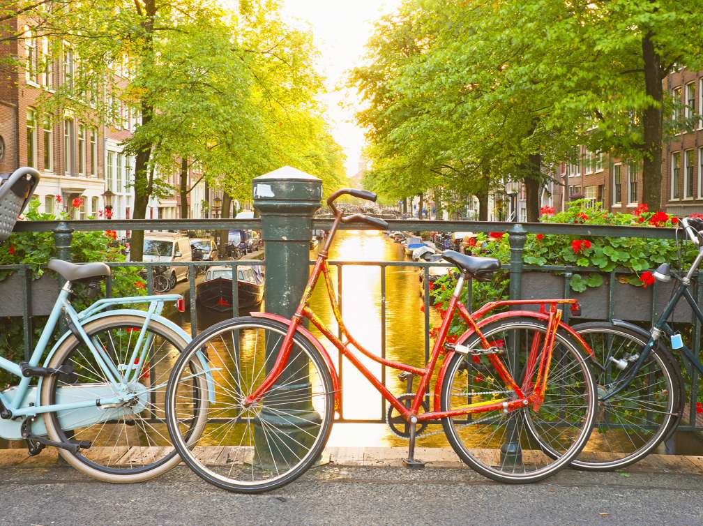 Bikes tied up on bridge over the canal in Amsterdam