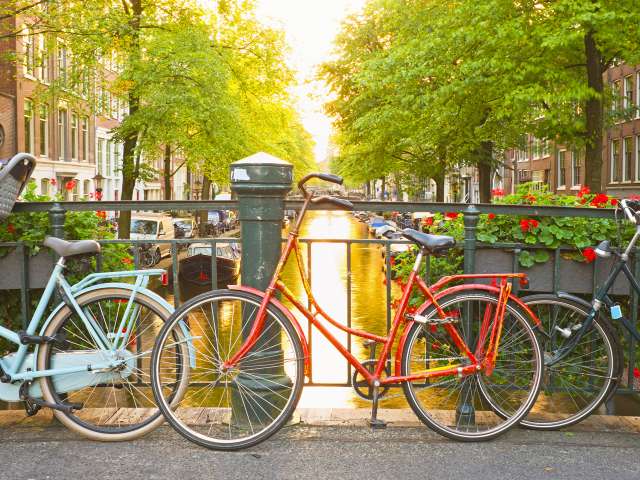 Bikes tied up on bridge over the canal in Amsterdam