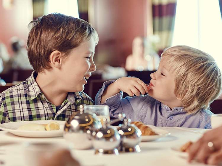 Little brothers enjoying eating food together