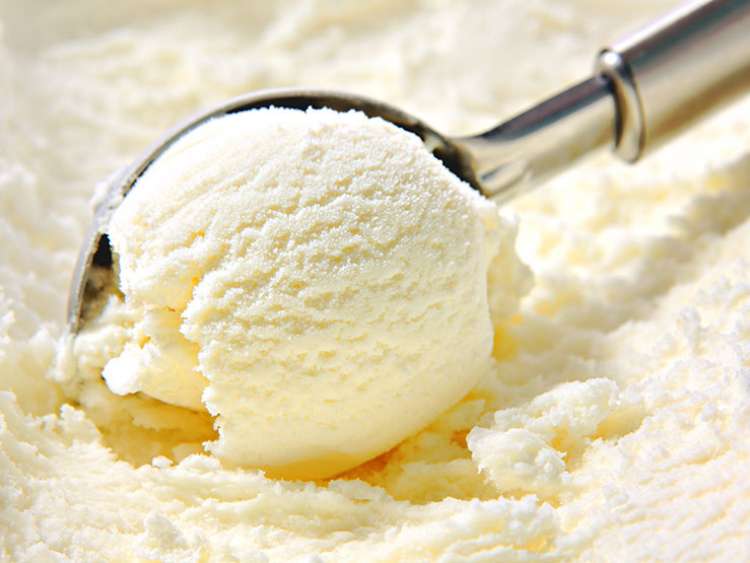 Vanilla ice cream being scooped up 