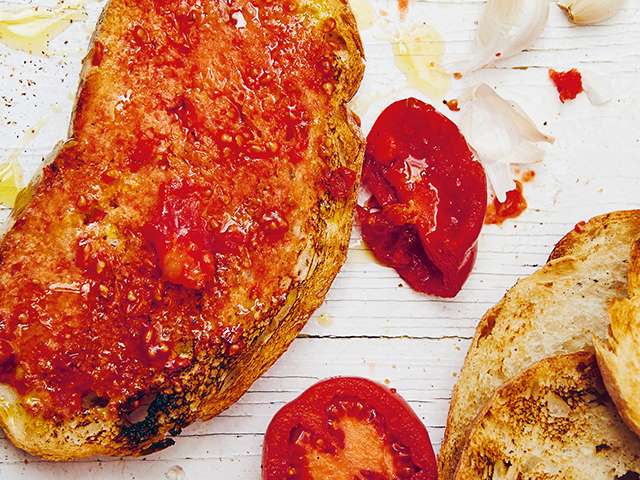 Tomato on bread served on a wooden board 