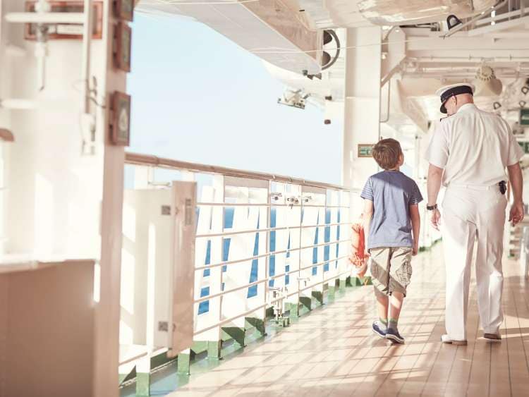 Boy and Captain walking along talking