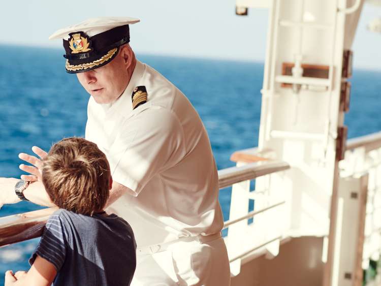 Captain talking to boy on deck on board a P&O Cruises cruise ship