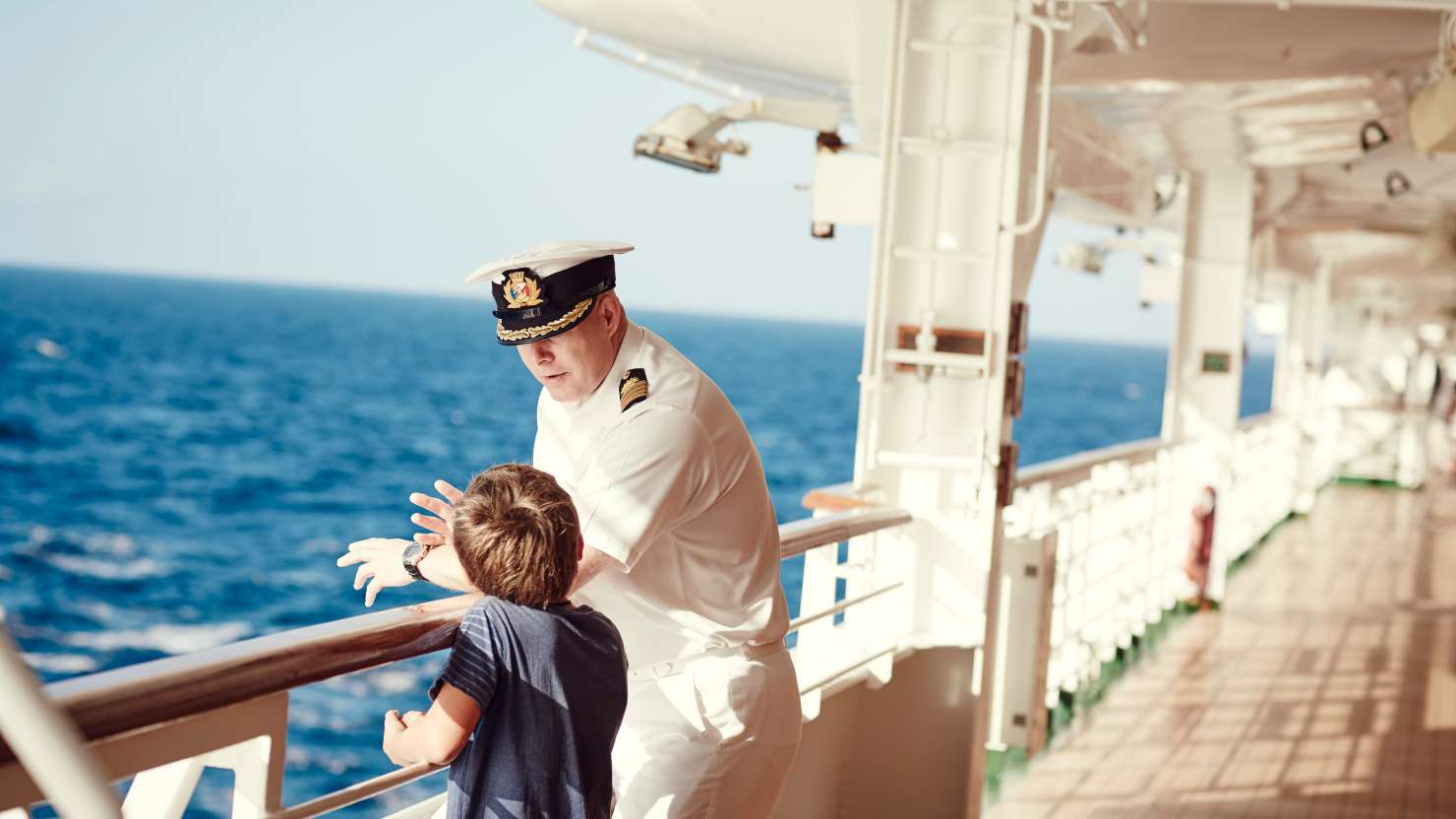 Captain talking to boy on deck on board a P&O Cruises cruise ship