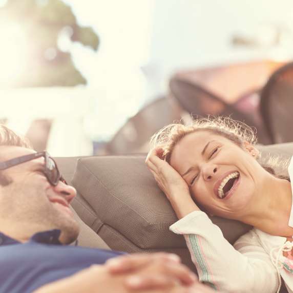 Couple laughing on deck chairs