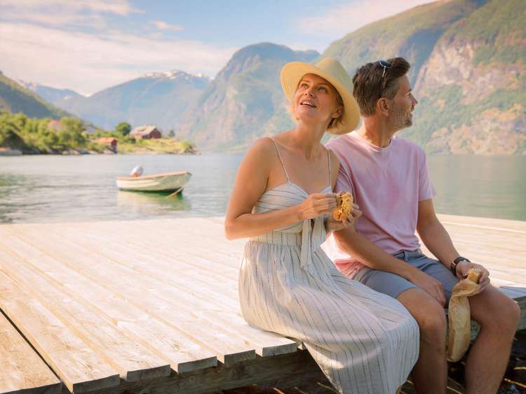 Couple sat by lake together