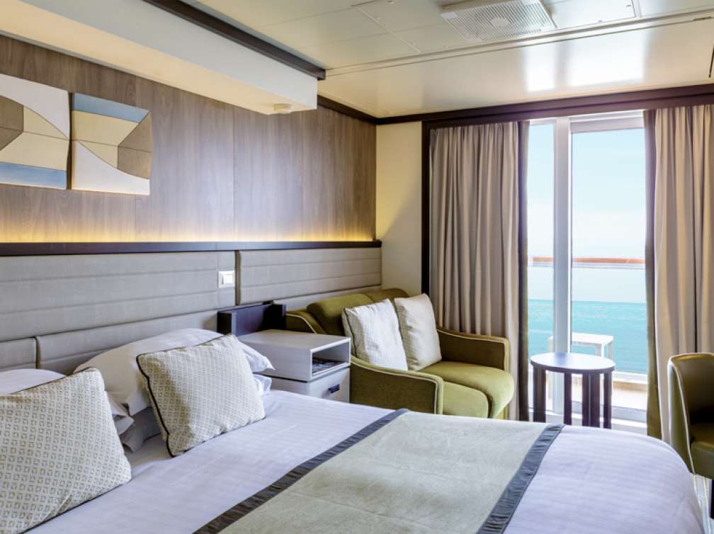  Double bed and sofa in a balcony cabin