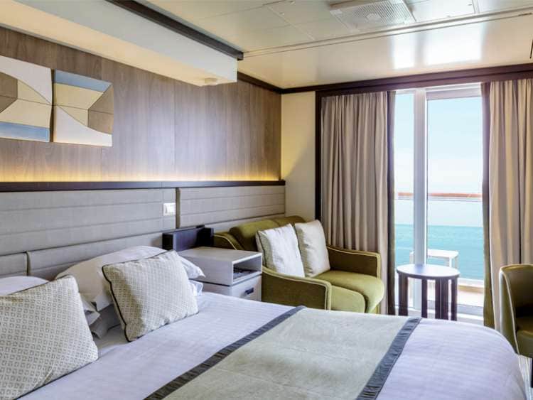 Double bed and sofa in a balcony cabin