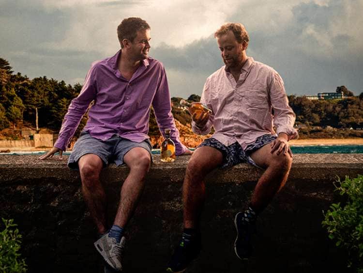 Founders of Tidal Rum looking at a bottle of Rum