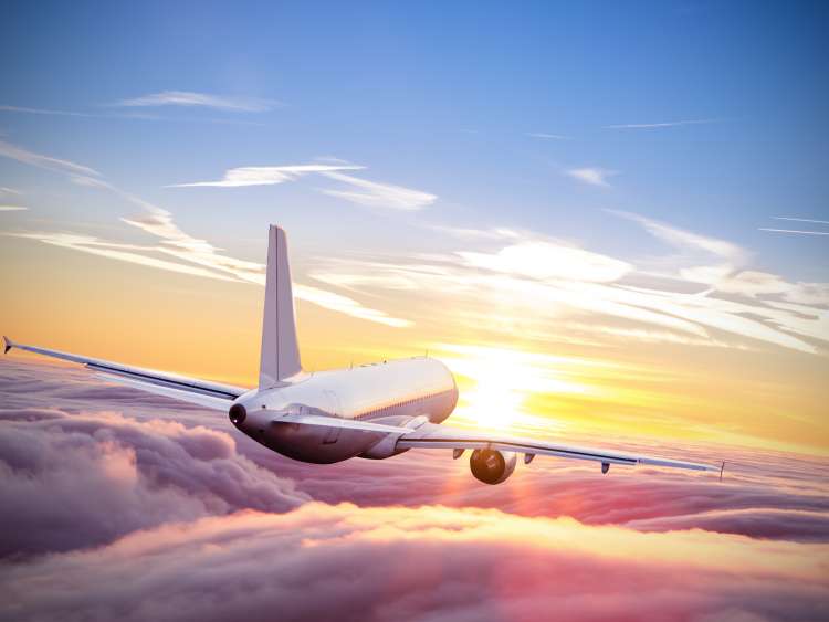 Plane riding into sunset