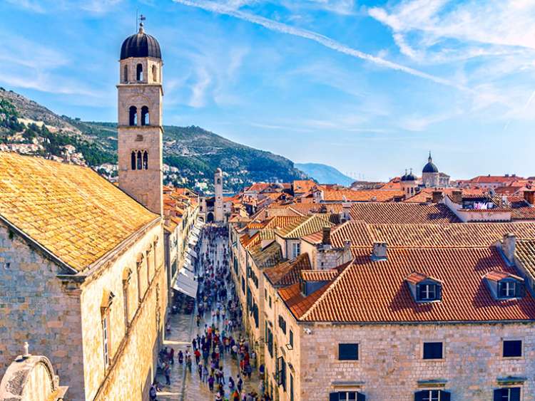 A high level view of Dubrovnik's main street with the Franciscan monastery and rooftops.