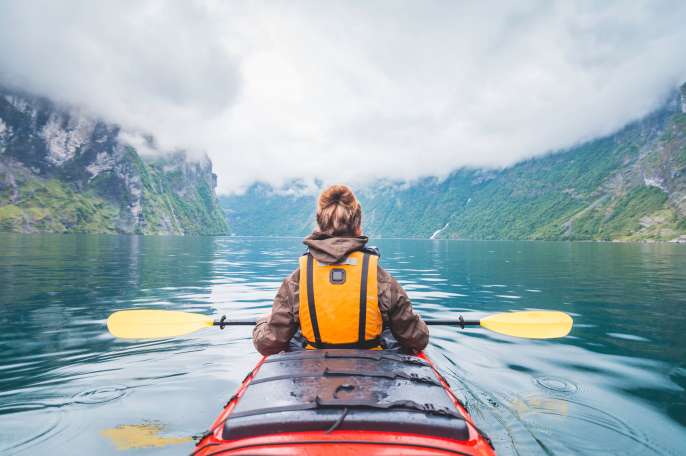 Person canoeing in the Norwegian Fjords