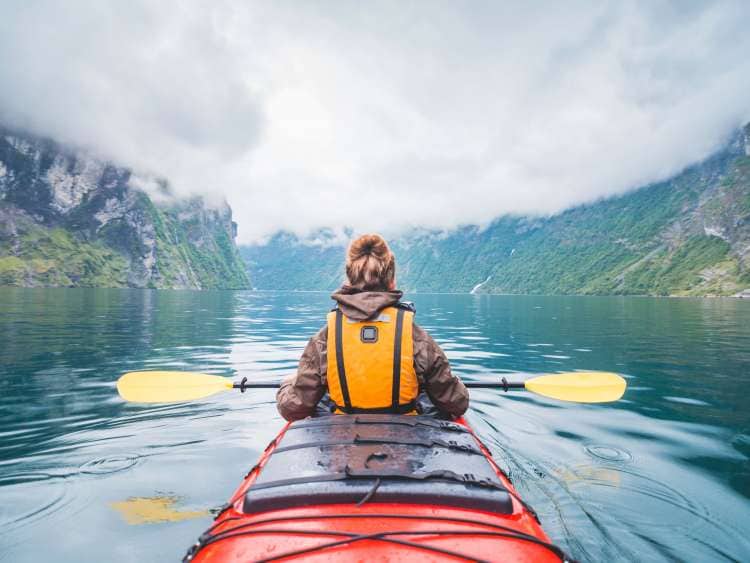 Person canoeing in the Norwegian Fjords