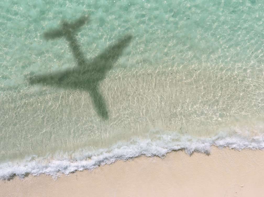 Aerial View Of A Shadow Of An Aero Plane Flying Over Beach