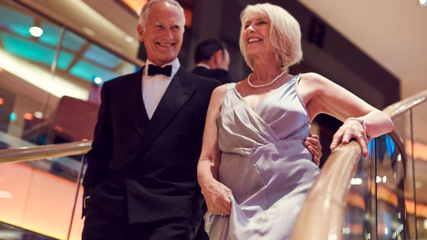 Couple walking down stairs in celebration night clothes