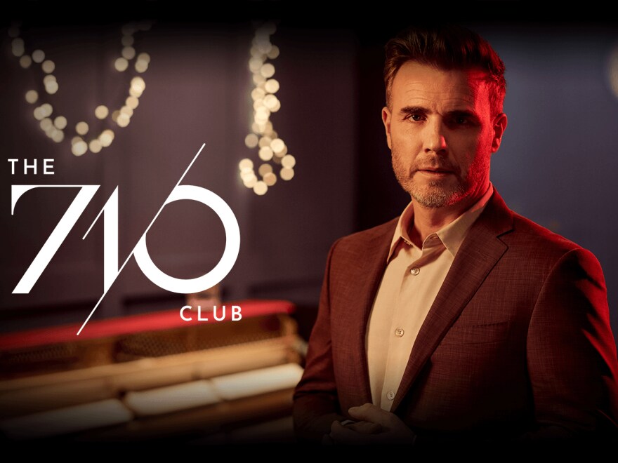 Gary Barlow posed next to 7/10 logo