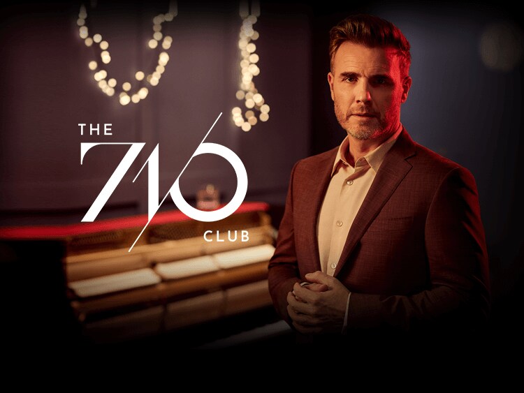 Gary Barlow posed next to 7/10 logo