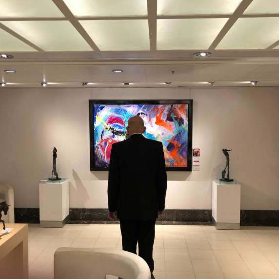 Relaxing- Man browsing art pieces