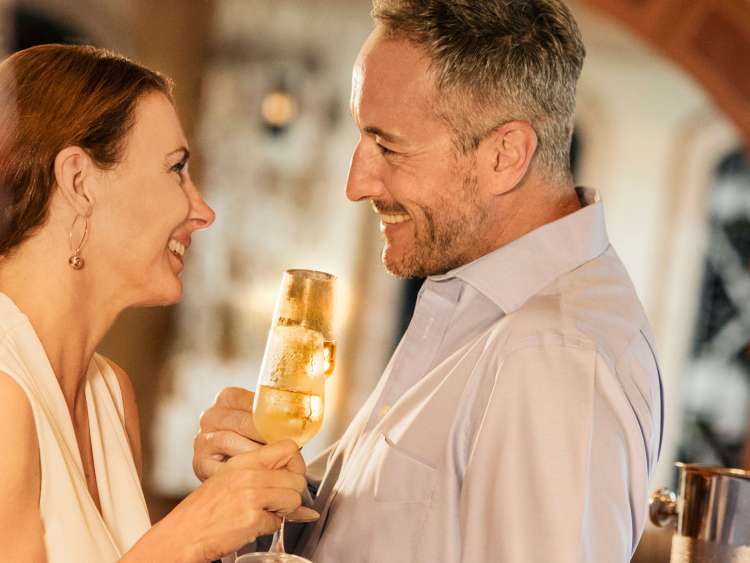 A couple drinking glasses of champagne together