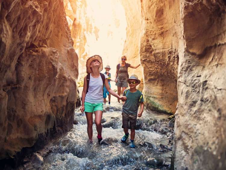 family exploring in rocky tunnel
