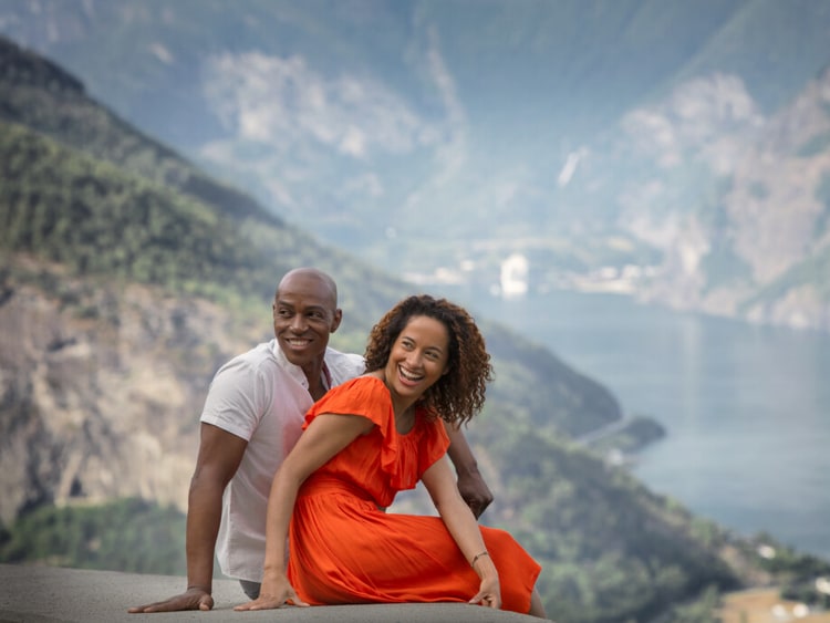 Couple sitting on a wall looking backwards