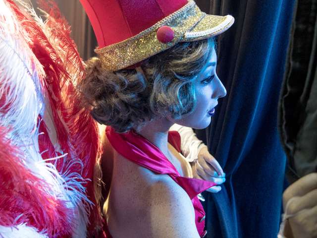 Theatre performer peeking through curtain