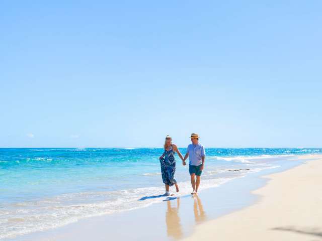 Couple walking along the beach in Caribbean