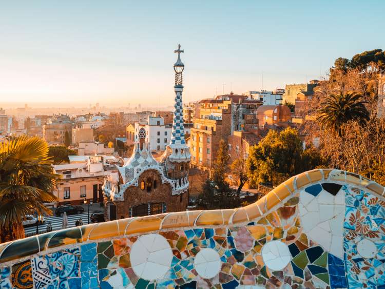 View of the city from Park Guell in Barcelona, Spain with sunrise colors.
