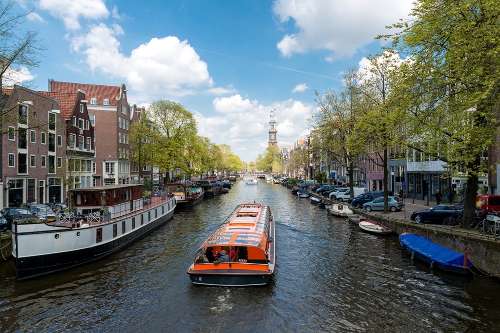 Westerkerk church with cruise ship in canal at Amsterdam, Netherlands.Beautiful spring season in Amsterdam, Netherlands.; Shutterstock ID 500644582; Invoice Number: -