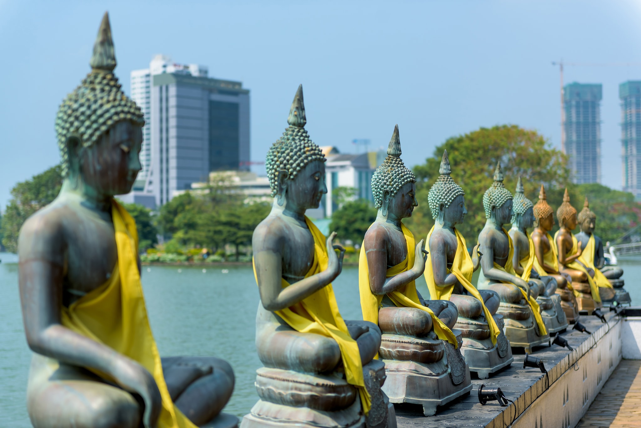 {"metadata_en_GB":{"alt-text":"Buddha statues infront of water "},"metadata_en_AU":{"alt-text":"Buddha statues infront of water "}}