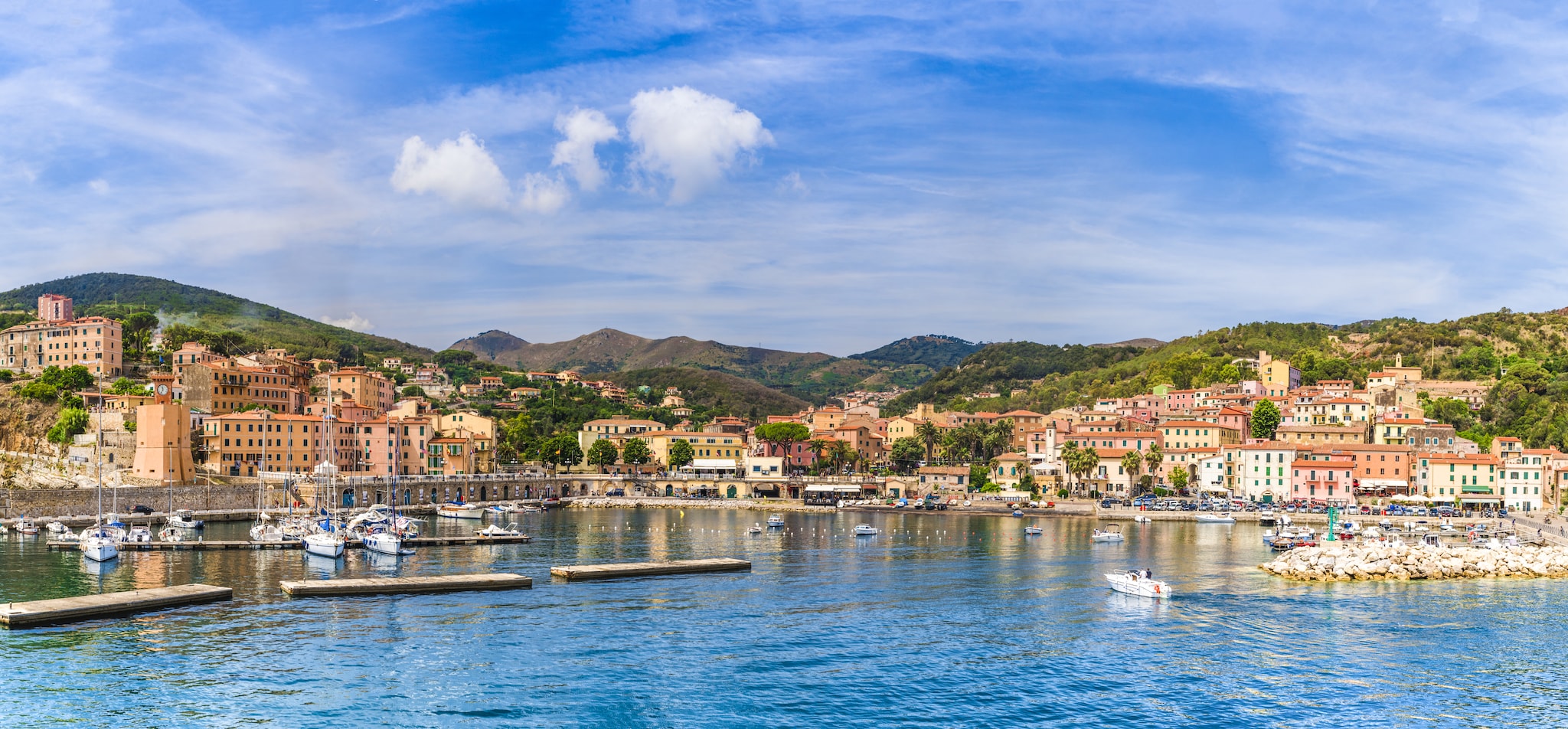 Harbour being overlooked by buildings and mountains