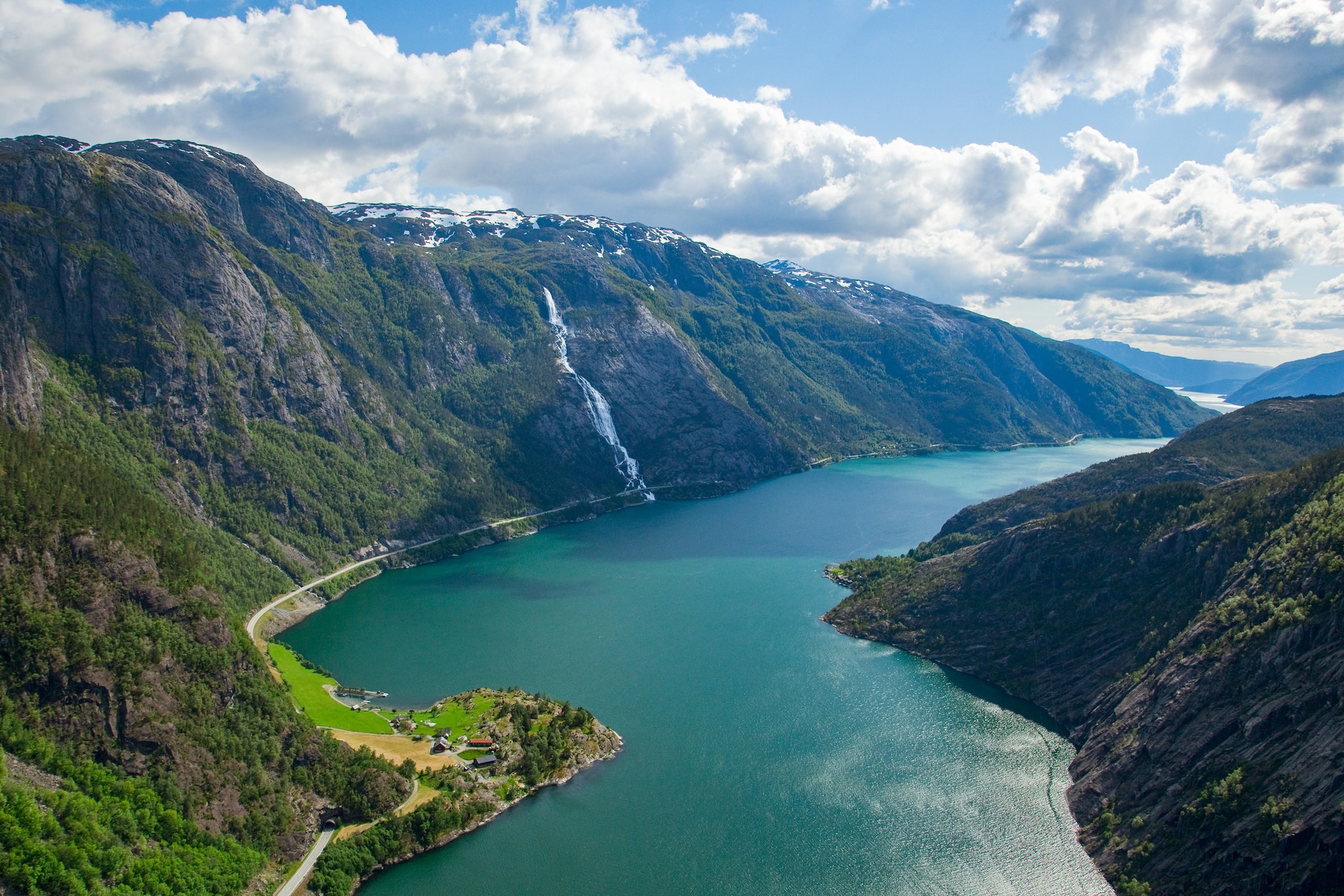 A landscape of the Langfoss waterfall and mountains in Akrafjorden, Norway