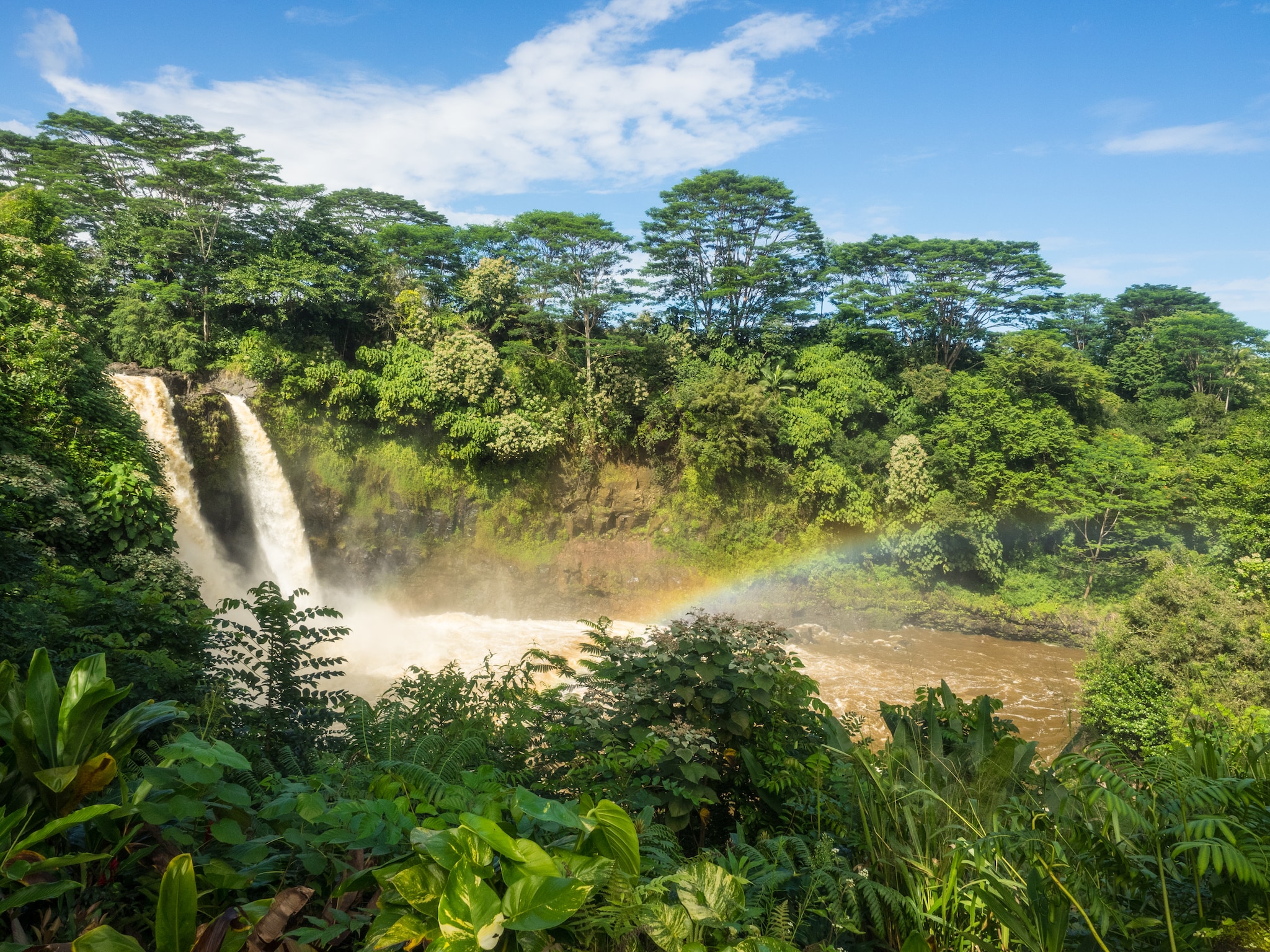 {"metadata_en_GB":{"alt-text":"Small rainbow in waterfall surrounded by trees "},"metadata_en_AU":{"alt-text":"Small rainbow in waterfall surrounded by trees "}}
