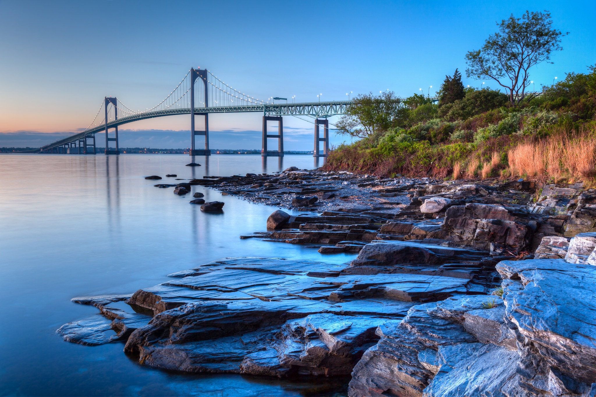 {"metadata_en_GB":{"alt-text":" A bridge over water with an evening sky"},"metadata_en_AU":{"alt-text":" A bridge over water with an evening sky"}}