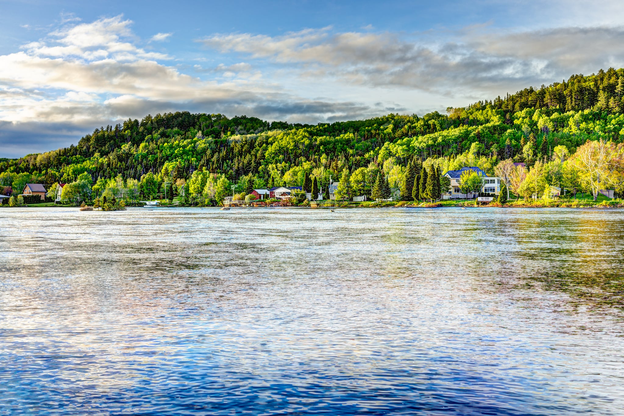 {"metadata_en_GB":{"alt-text":"Green mountains with cabins and small buildings by the sea"},"metadata_en_AU":{"alt-text":"Green mountains with cabins and small buildings by the sea"}}