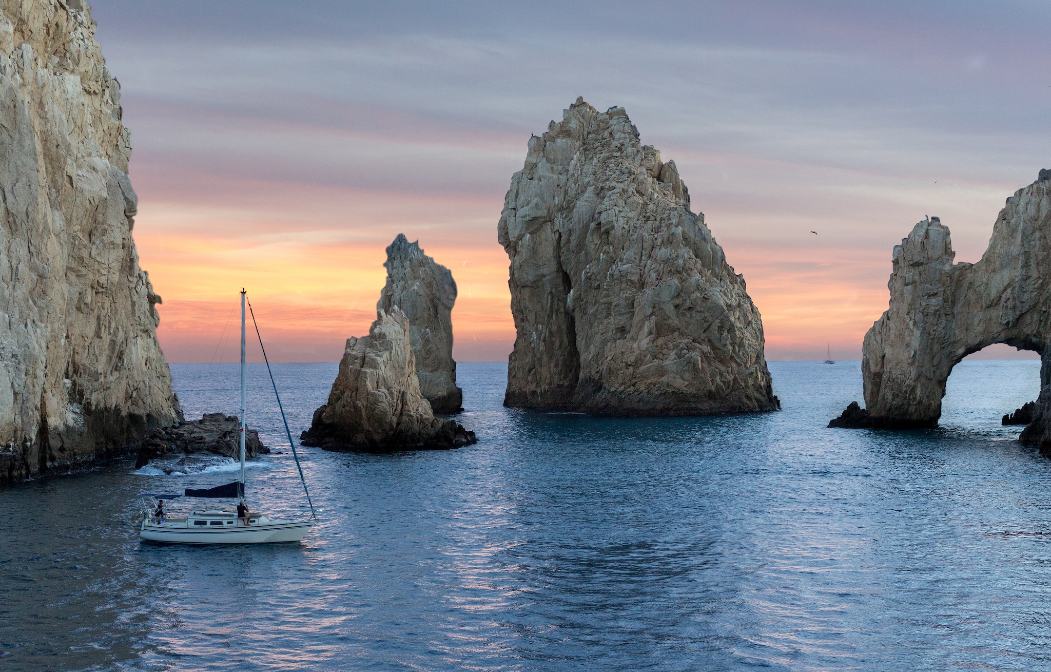 {"metadata_en_GB":{"alt-text":"Rocks in the sea with boat sailing in front of them"},"metadata_en_AU":{"alt-text":"Rocks in the sea with boat sailing in front of them"}}