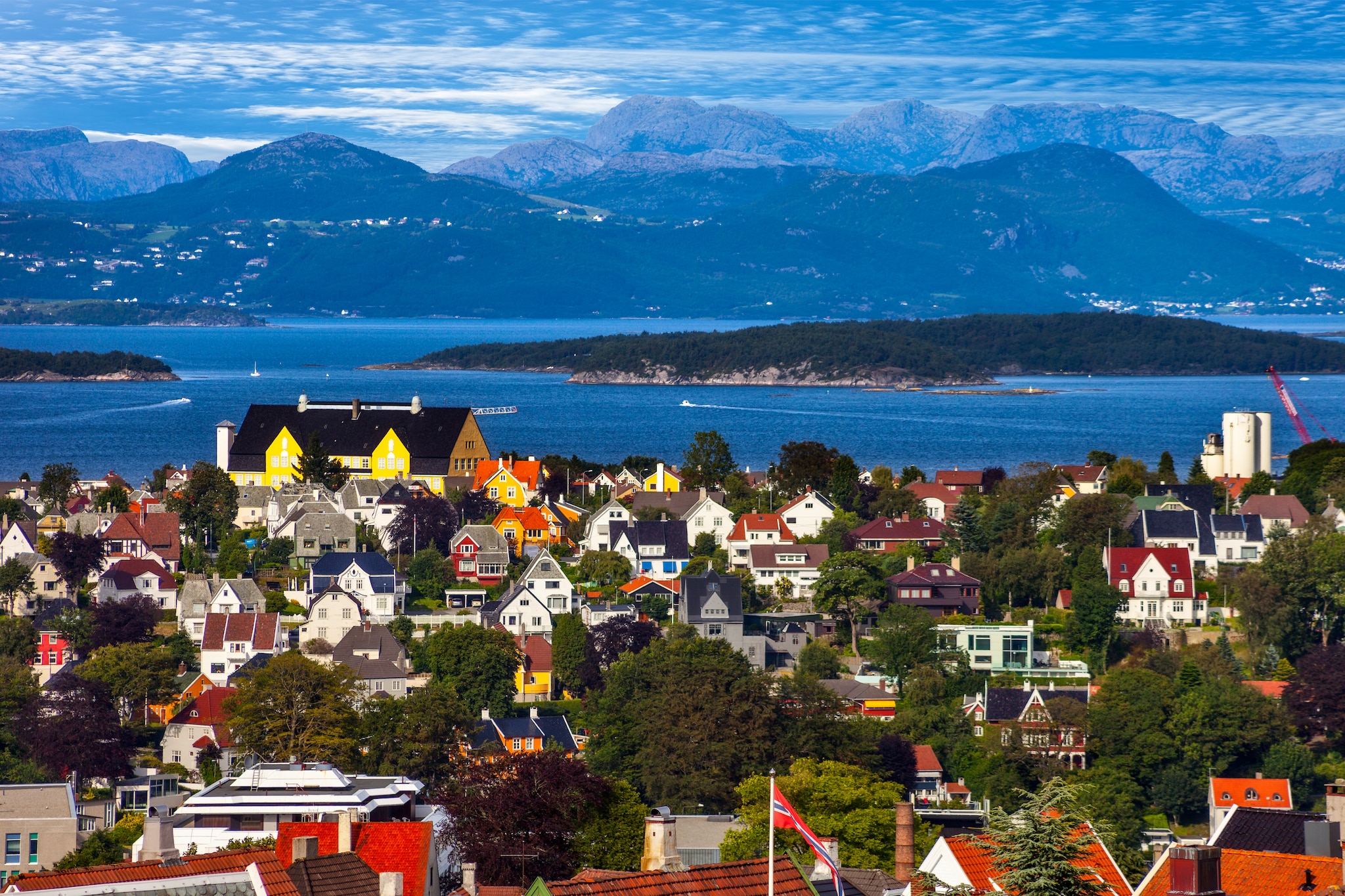 Houses infront of water and mountains