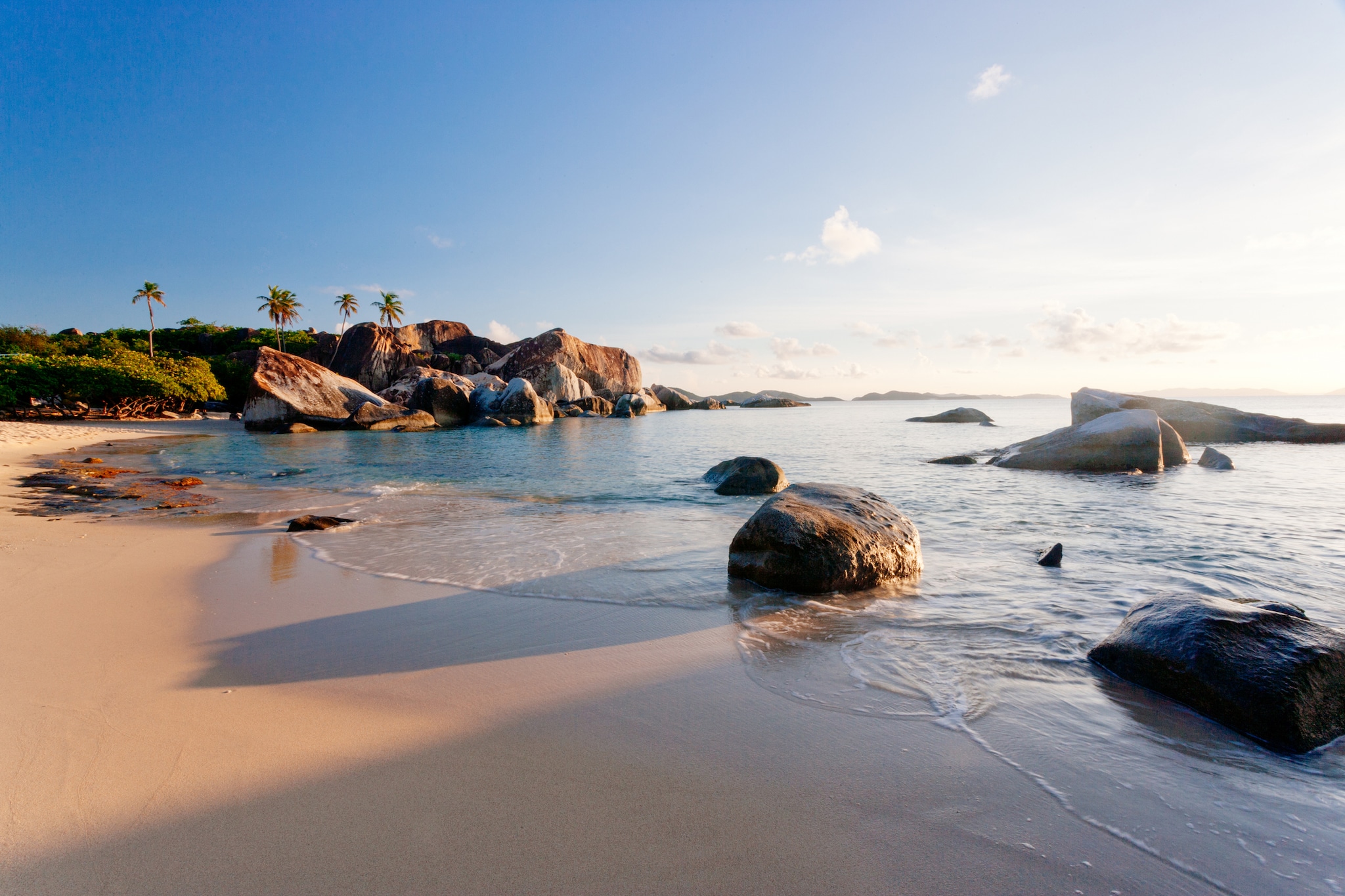 Tropical beach in Caribbean. Virgin Gorda, British Virgin Islands, Caribbean. Palm tree's and boulders with golden sand.