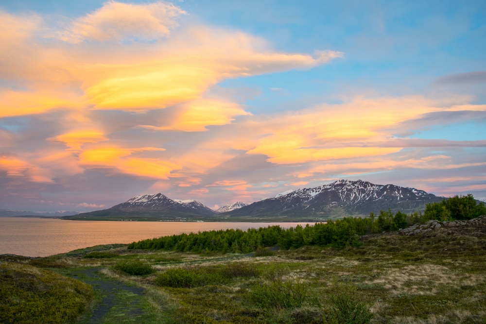 {"metadata_en_GB":{"alt-text":"The sunset is reflected in the clouds near island of Hrisey in Iceland; Shutterstock ID 1136443367; Project: Adobe"}}