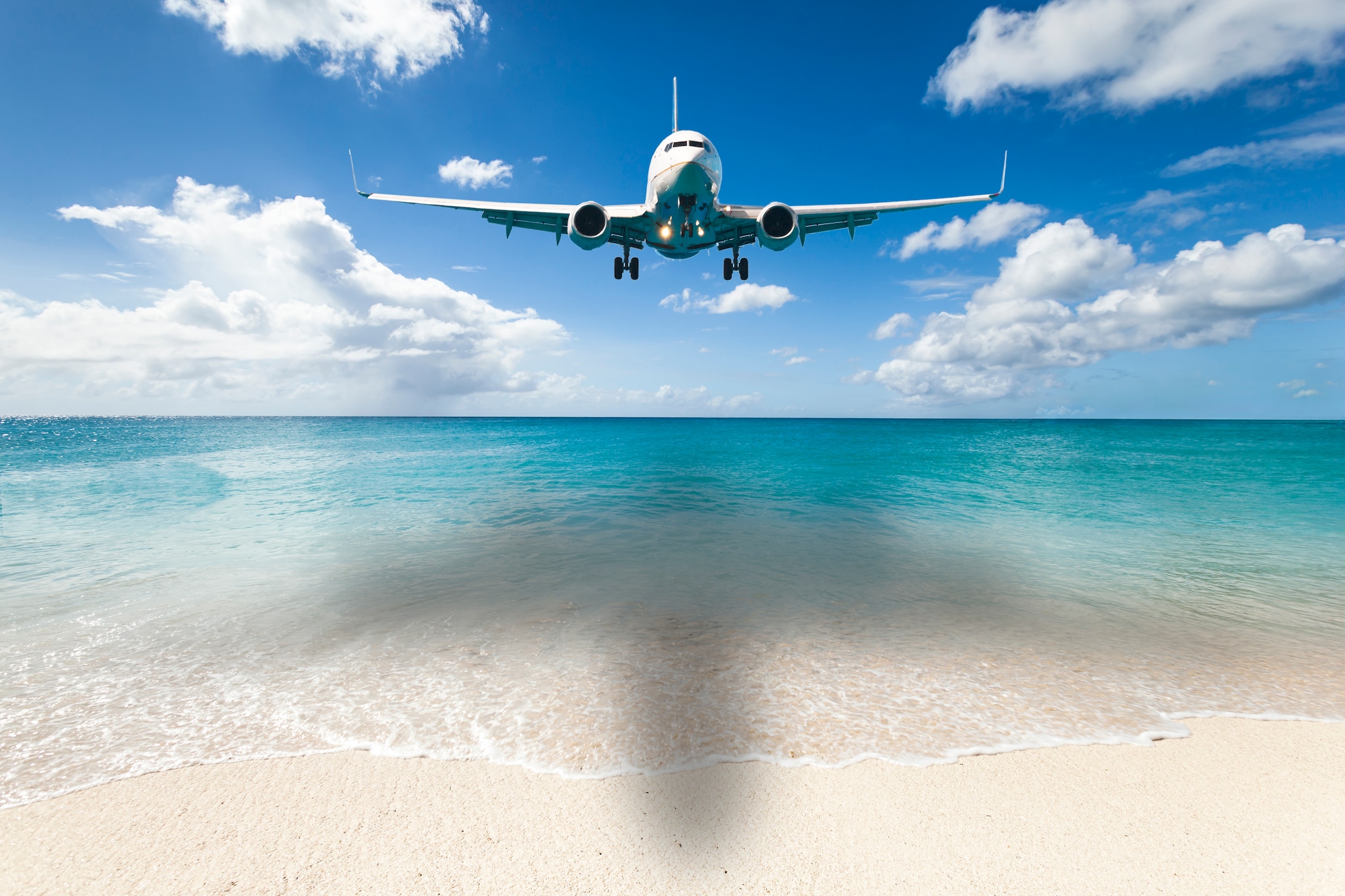 Aircraft landing at Princess Juliana International Airport in Netherlands Antilles.