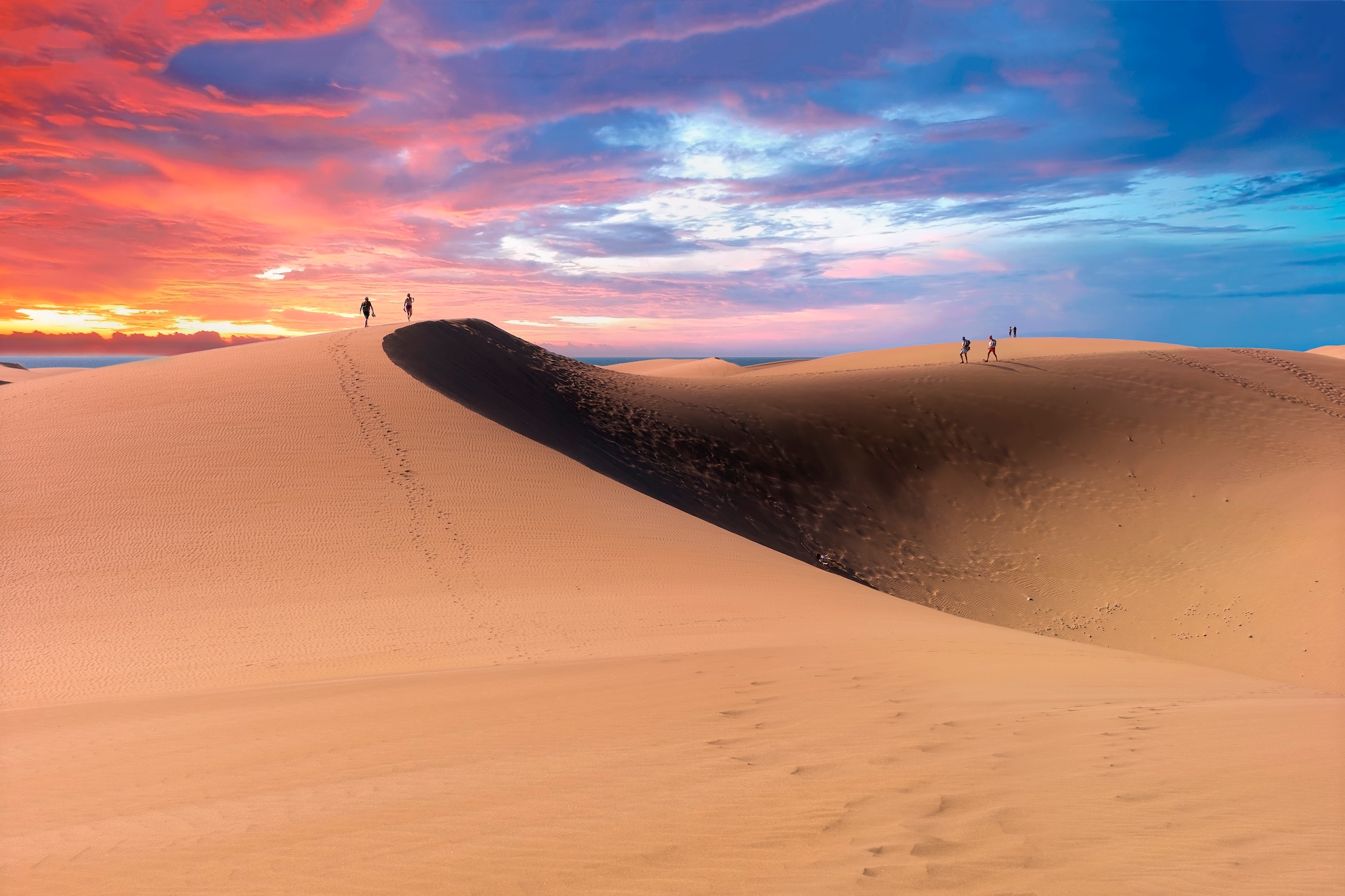 The Maspalomas Dunes are sand dunes located on the south coast of the island of Gran Canaria, Province of Las Palmas, in the Canary Islands. They were formed by sand from the now subdued marine shelf, when it was laid dry during the last ice age and the wind blew the sand towards the coast of the island.
