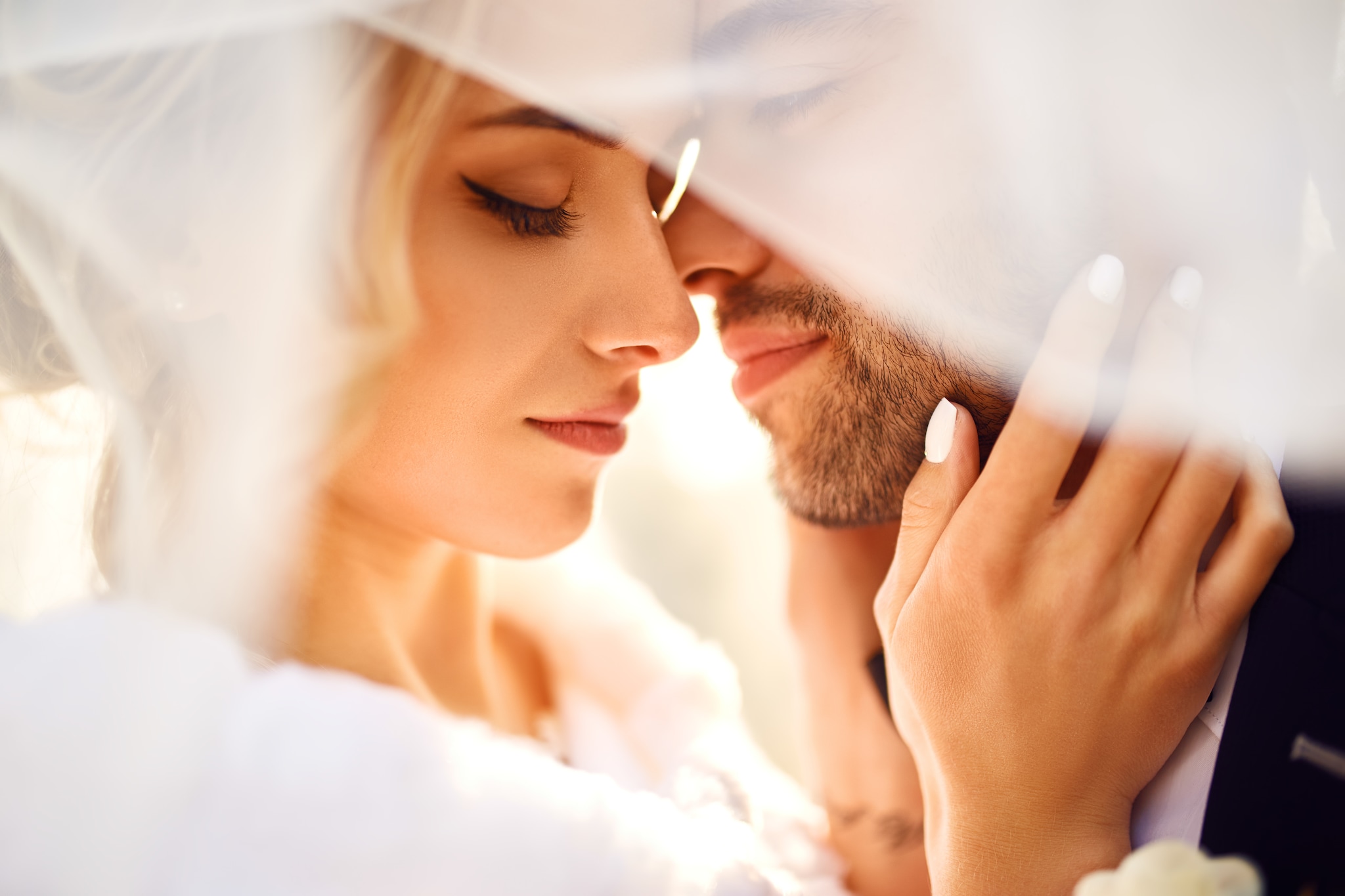 young and beautiful bride and groom enjoy each other. in the shadow of a flying veil. nice wedding day