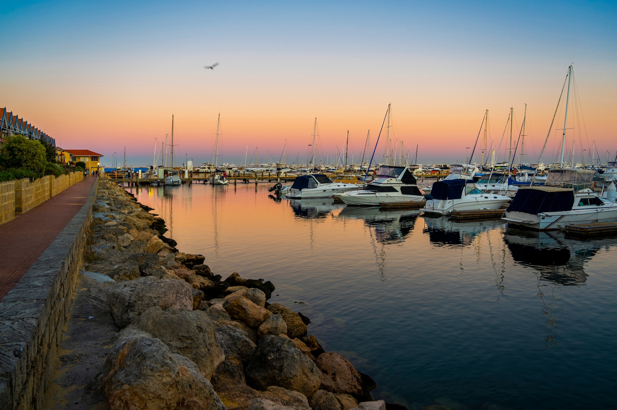 {"metadata_en_GB":{"alt-text":"Dramatic and tranquil sunset sea view by the public walkway along jetty area next to Thomson Bay nearby Rottnest Island visitor centre - Perth, Western Australia. Rottnest Island is also known as Wadjemup locally"}}