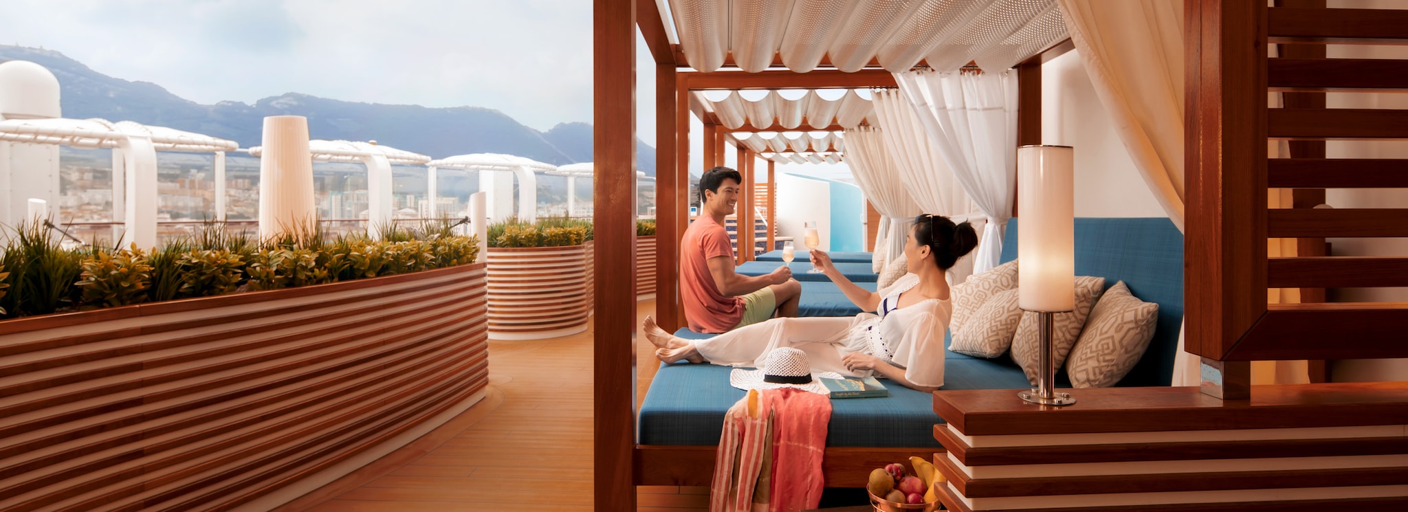{"metadata_en_GB":{"alt-text":"Couple enjoying a drink on a sunbed in The Retreat on P&O Cruises ship Iona"}}