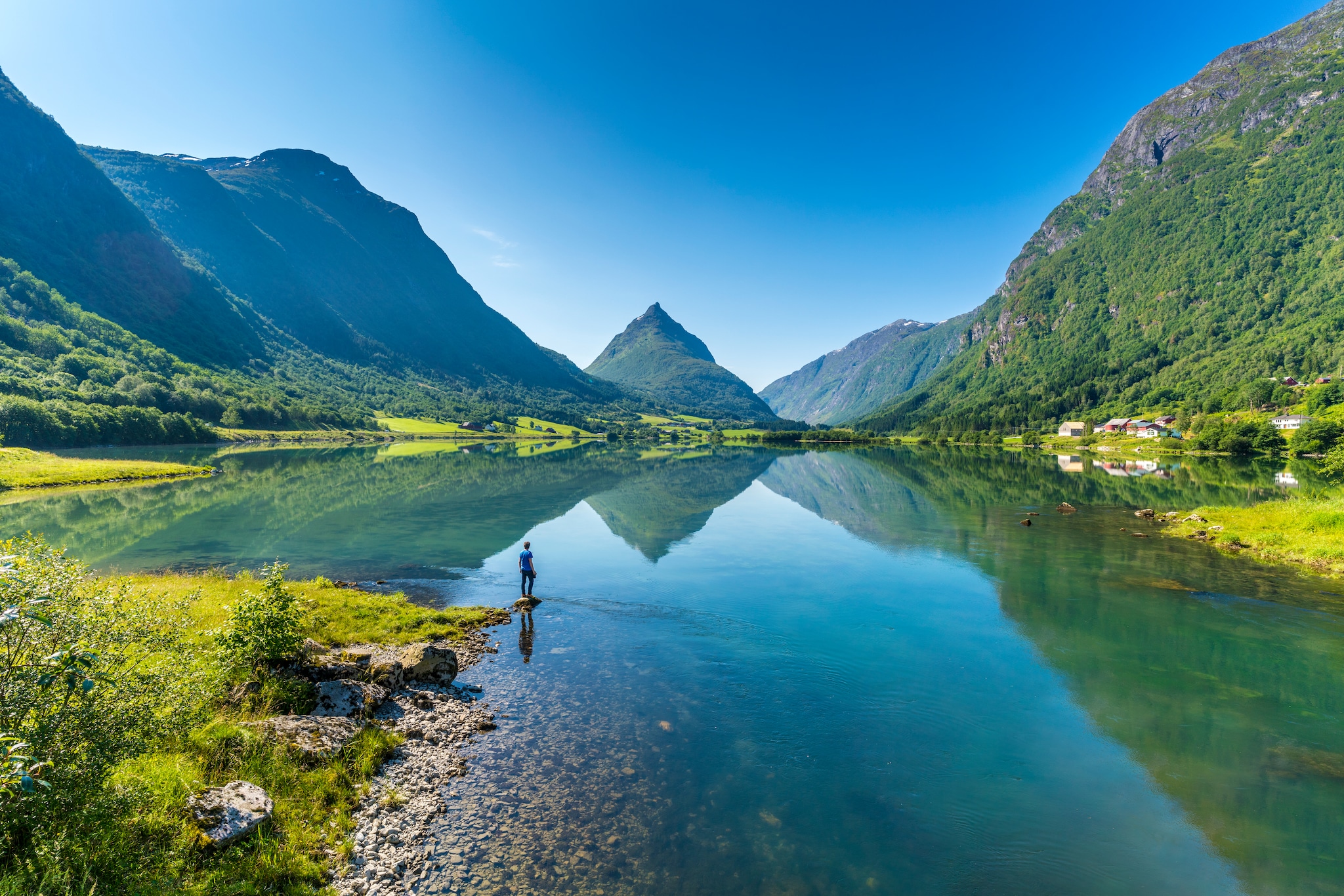 {"metadata_en_GB":{"alt-text":"Man on banks of lake Bergheimsvatnet admiring Mount Eggenipa along the western fjords, Nordfjord, Sogn og Fjordane, Norway"}}