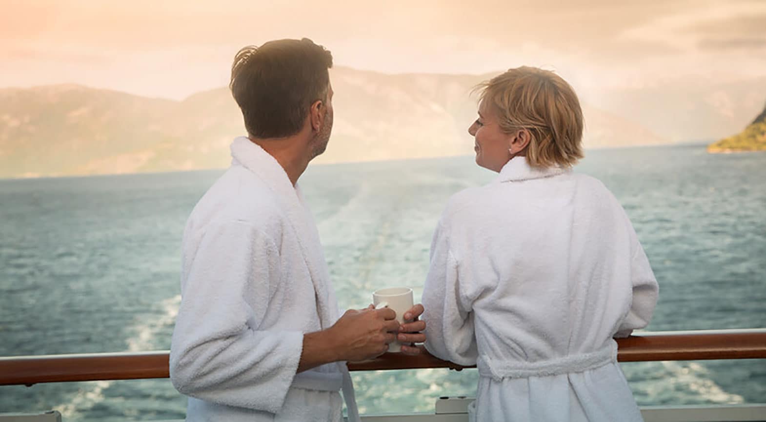 Couple in bathrobes on balcony
