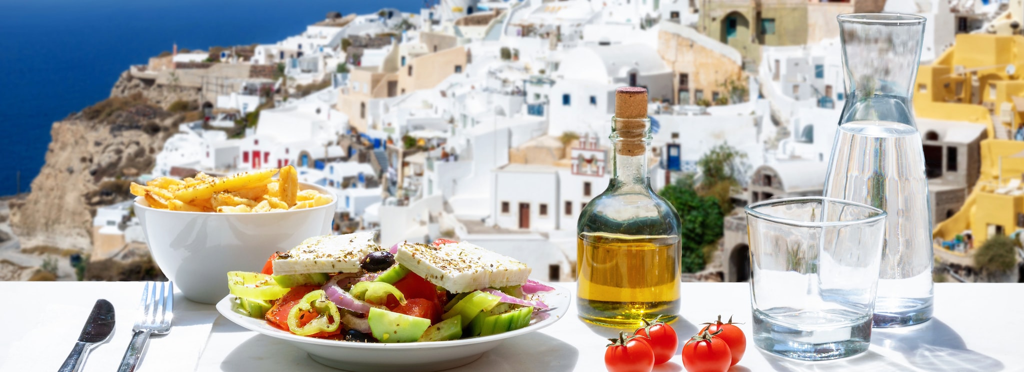 {"metadata_en_GB":{"alt-text":"Food sat on balcony in Santorini"},"metadata_en_AU":{"alt-text":"Food sat on balcony in Santorini"}}